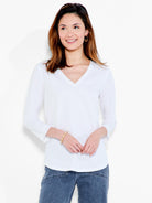 A white v-neck top featuring a relaxed fit, three-quarter sleeves, and a simple rounded hemline.