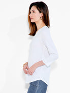 This white v neck blouse features a relaxed fit with long sleeves and a curved hem for a classic clean style.