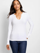 White ribbed long-sleeve shirt, split neckline.
