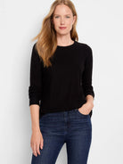 Black long-sleeve shirttail tee;  round neckline;  shown with dark wash jeans.