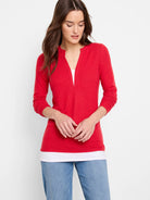 Red long-sleeve top with a small V-neckline.  Slight texture visible. White undershirt shows at neckline.