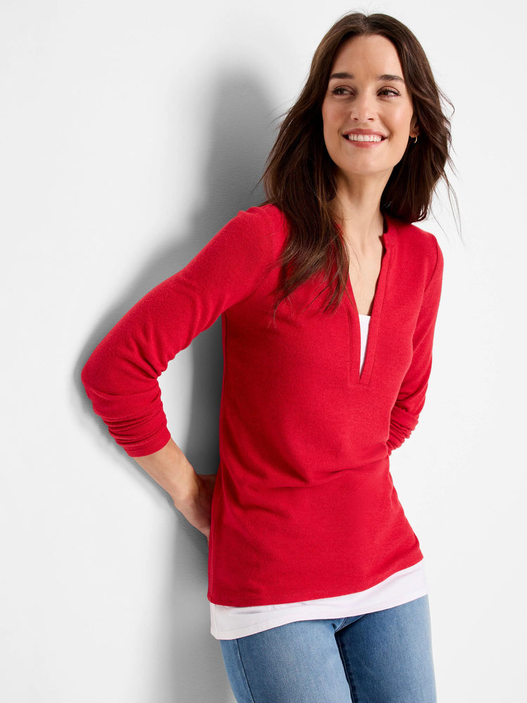 Red long-sleeve top with a V-neck and a hint of white layering.