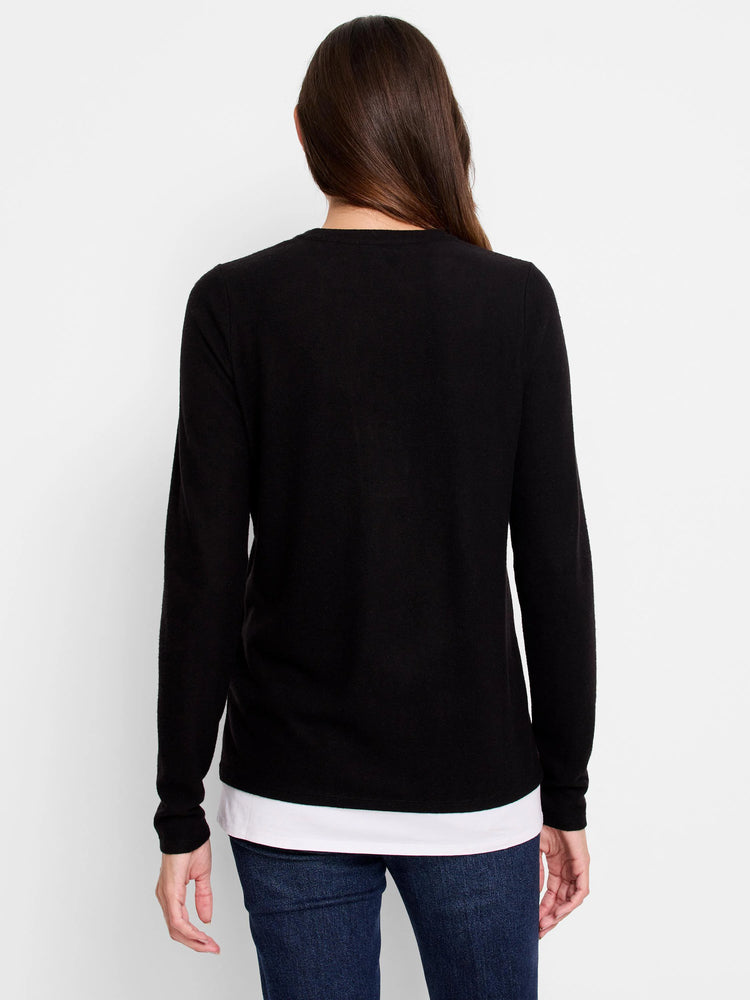 Black long-sleeve top layered over white, shown from the back.