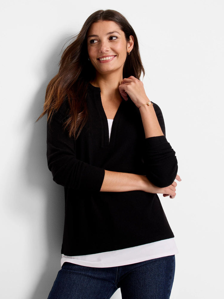 Black long-sleeve top, V-neck, layered over white shirt.