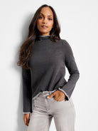 Dark gray mock neck top with lighter gray trim at neckline and cuffs; long sleeves.