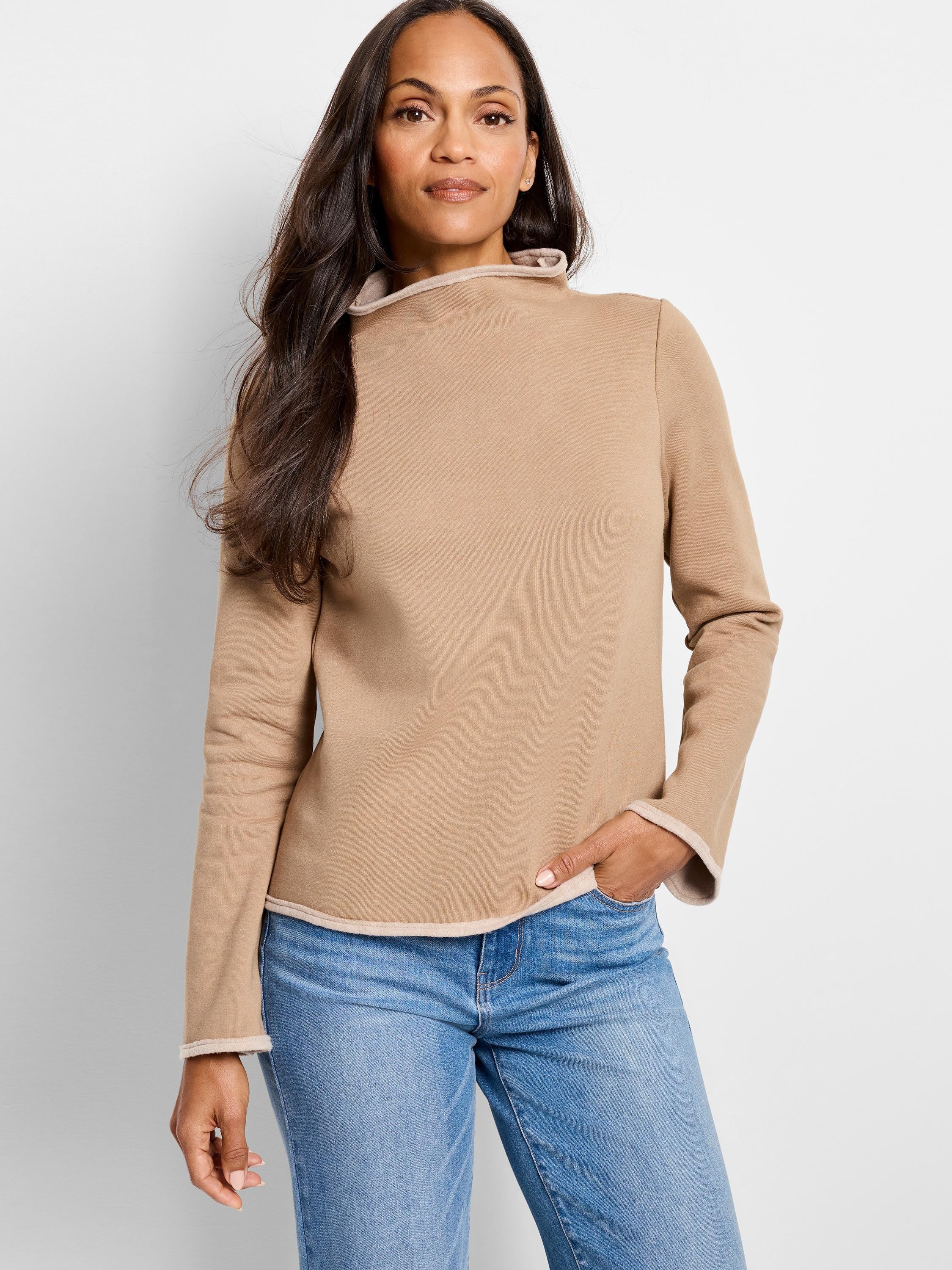 Beige long-sleeve top with lighter beige trim at neckline and cuffs.  High neckline.