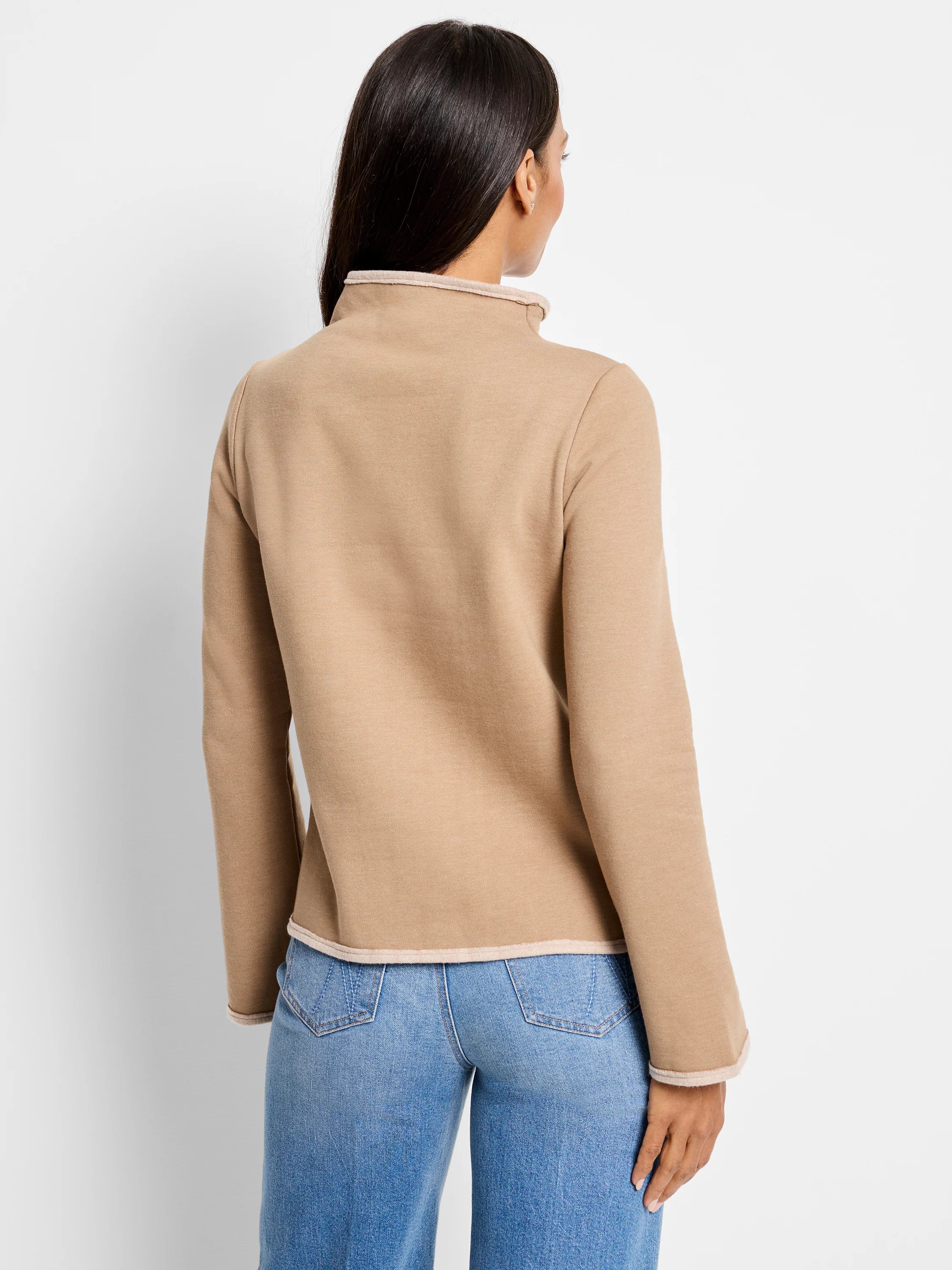 Beige mock-neck top with light beige trim at neck and cuffs.  Long sleeves.  Rear view.