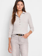 Light gray long-sleeve polo shirt with dark buttons.  Model wears light gray jeans.