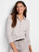 Light gray long-sleeve polo shirt with a collared henley neckline and  five button placket.