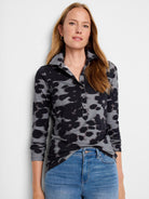 Long-sleeve polo shirt with a gray and black abstract print.  Button placket.