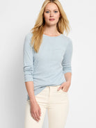 Light blue, long-sleeved, crew-neck shirt.  Heathered texture. Model wears off-white pants.