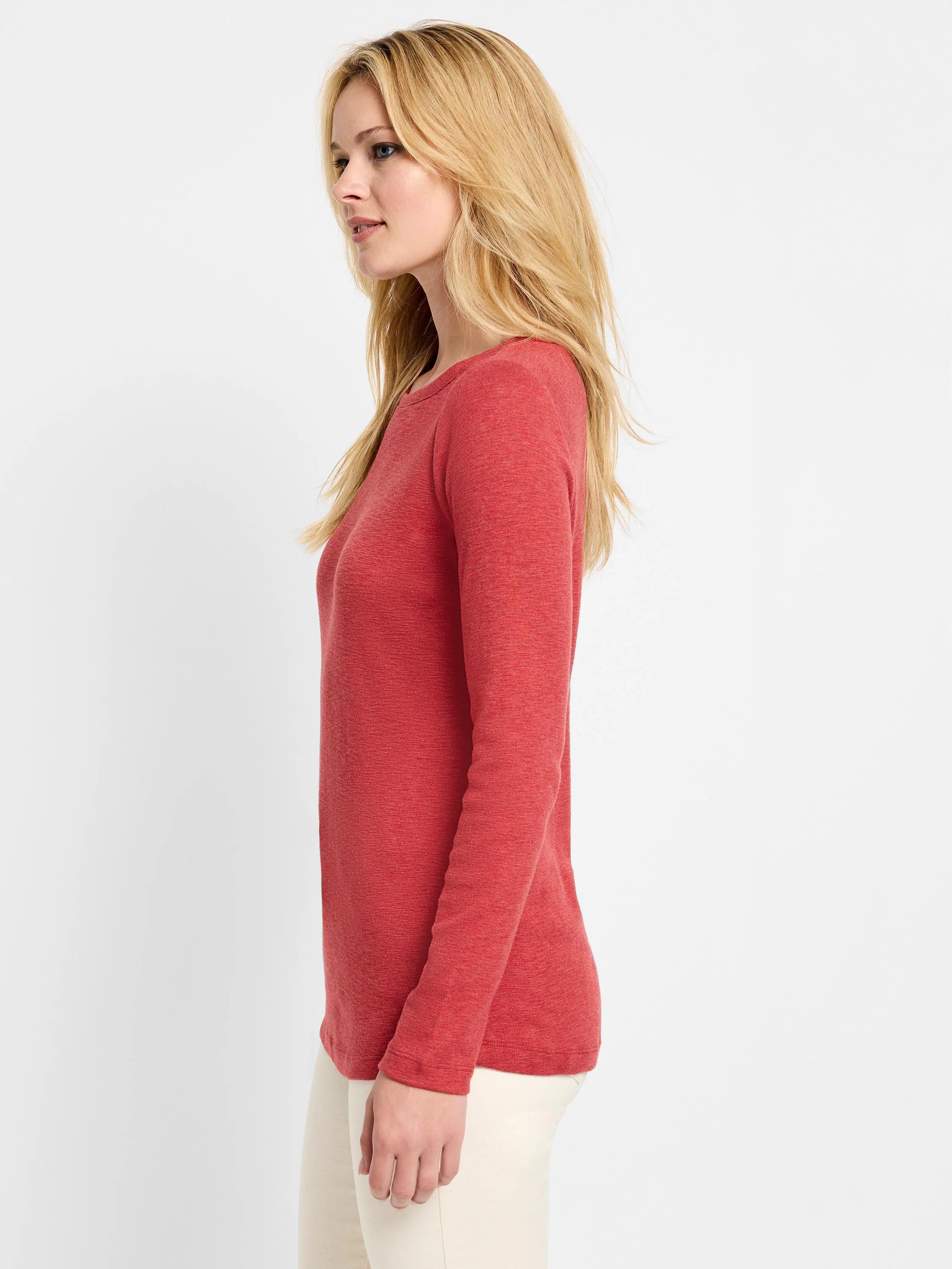 Red long-sleeved boatneck shirt; textured fabric.