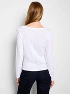 White long-sleeve boat neck tee on model, back view. Features a vertical seam down the back.