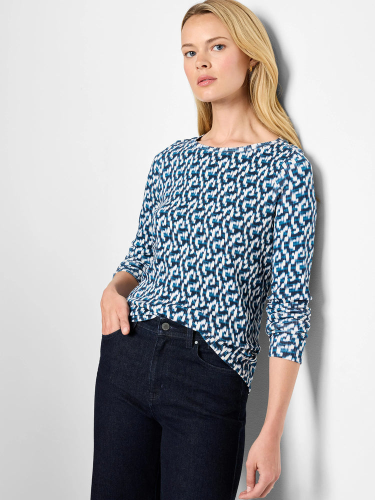 Long sleeve boat neck tee with a blue and white abstract geometric print.