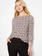 Cream long sleeve boat neck tee with a dark brown/black irregular vertical abstract print.