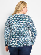Long-sleeve tee with cream, dark blue, and teal fragmented pattern.