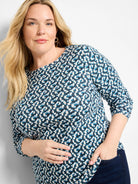 Long sleeve boat neck tee with blue, teal, and cream ikat-style geometric pattern.