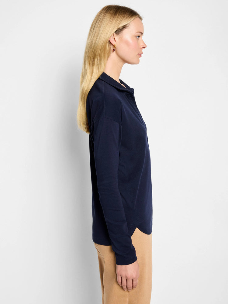 Navy long-sleeved polo top with a collar, relaxed fit, and curved hem.