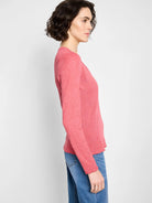 Coral pink, long-sleeved V-neck shirt.  Textured knit fabric with scalloped hem.