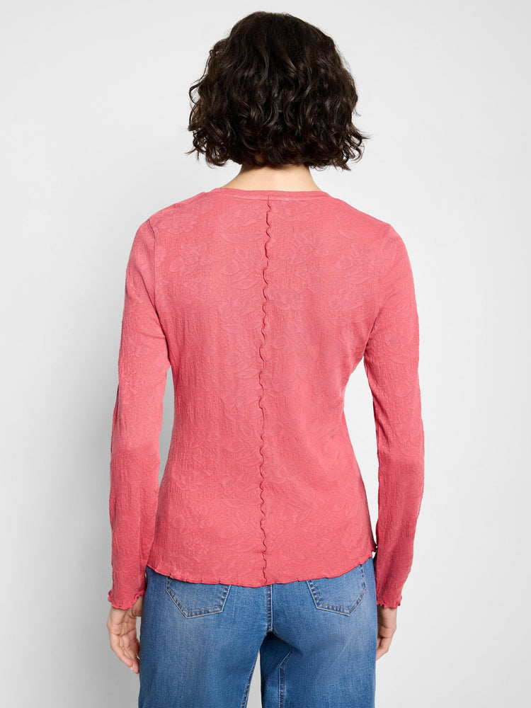 Coral pink, long-sleeved V-neck knit top with textured surface and scalloped hem.  Back view shown.