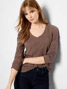 Brown, long-sleeved v-neck shirt.  Lace knit texture.  Slightly frayed cuffs.