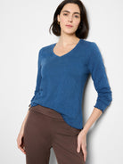 Blue, textured knit v-neck long-sleeve shirt with scalloped hem.