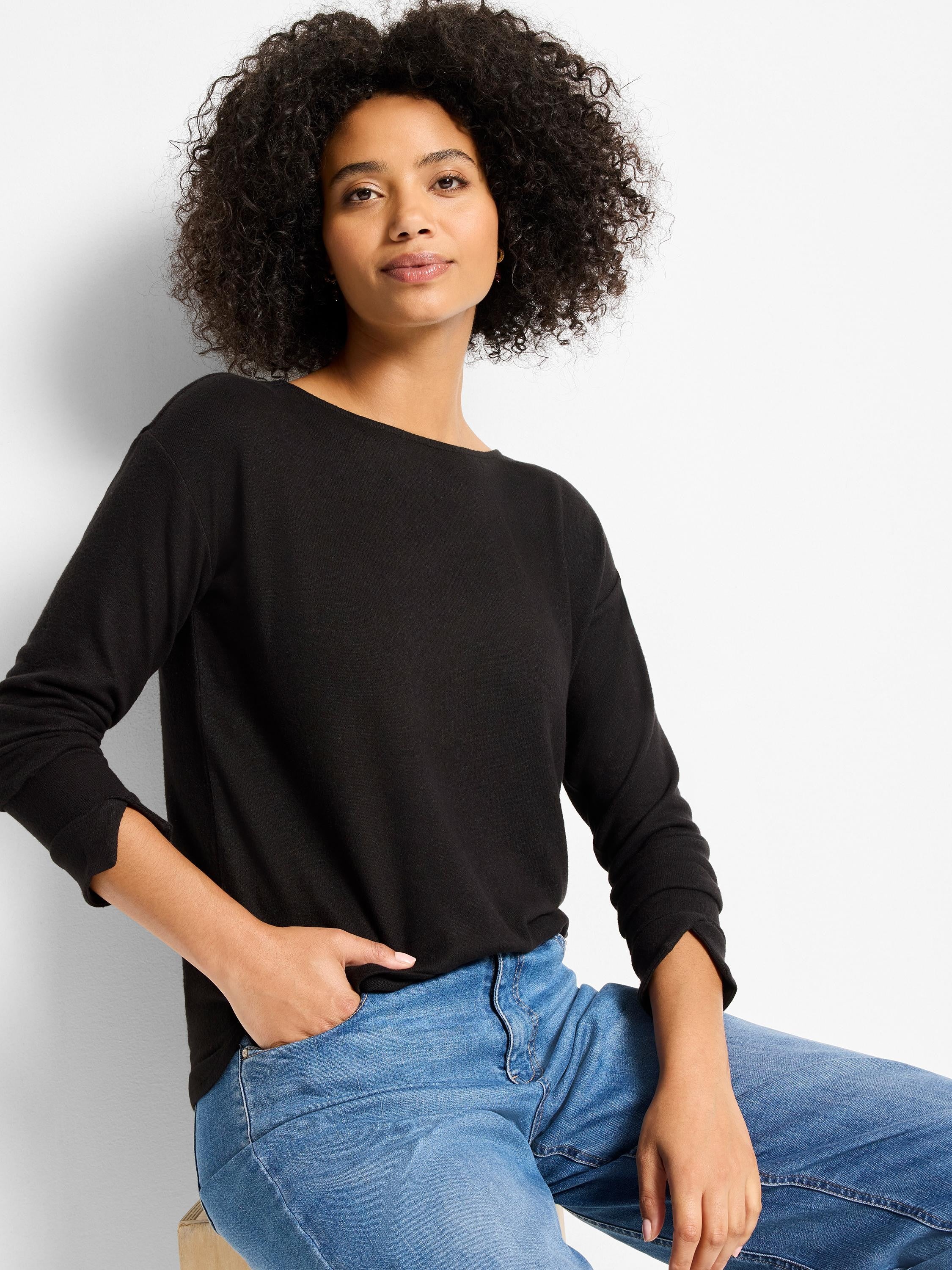 Black long-sleeved top with a wide neckline and unique slit cuffs, shown on a woman.