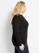 Black long-sleeved top with a round neck, slightly dropped shoulders, and a small slit detail on the cuffs.