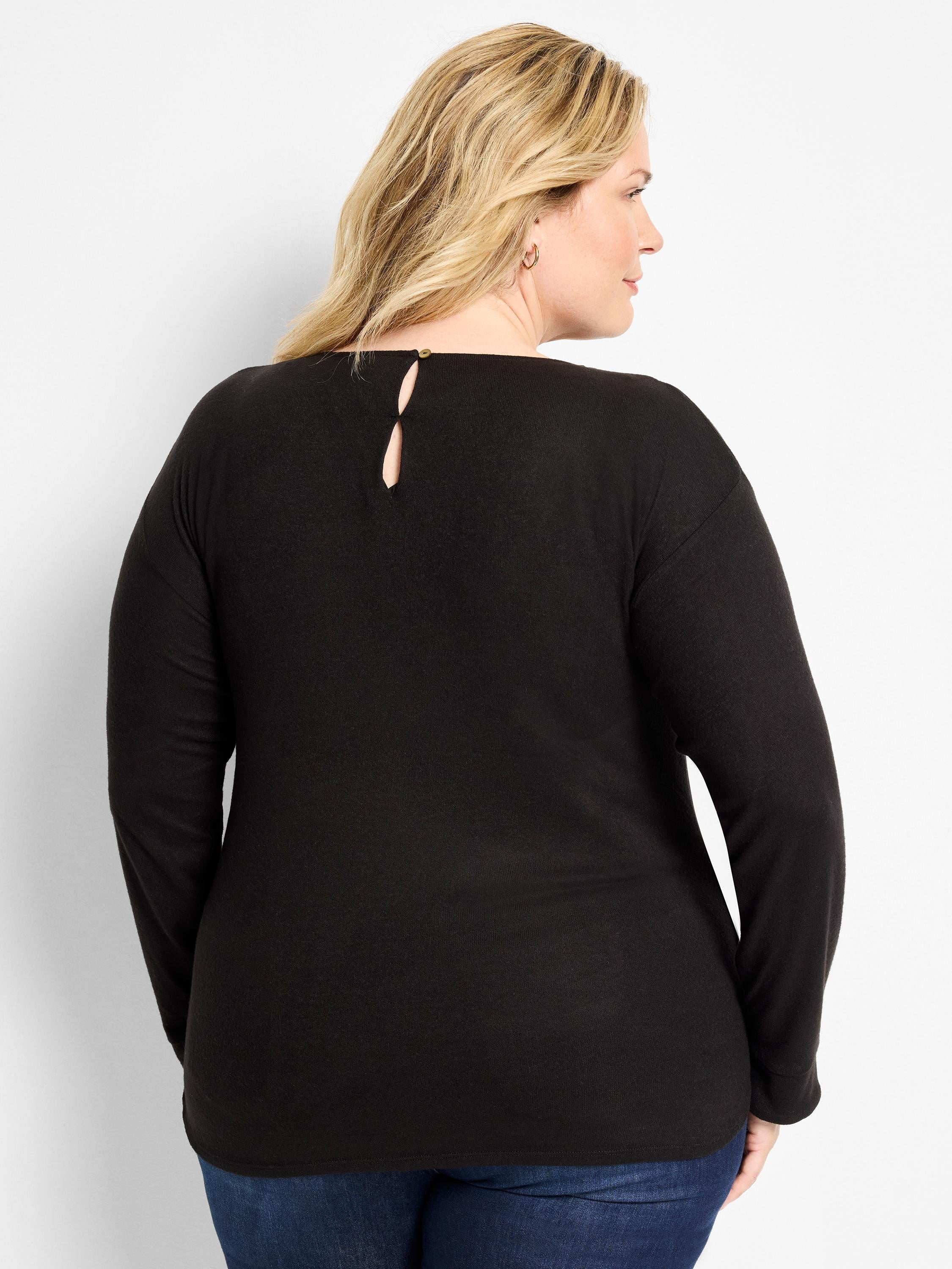 Black long-sleeve top. Round neck, keyhole back with small gold button.