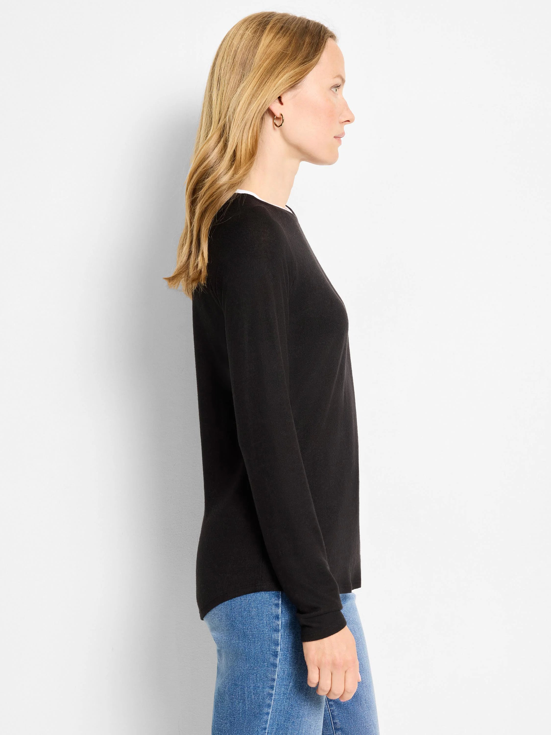 Black long-sleeved double-layered top with a white layer visible at the round neckline.