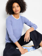 Light blue long-sleeved double-layered top with a white inner layer visible at the crew neck.