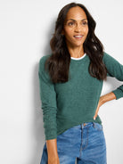 Green heathered long-sleeved top with white underlayer at crew neck.