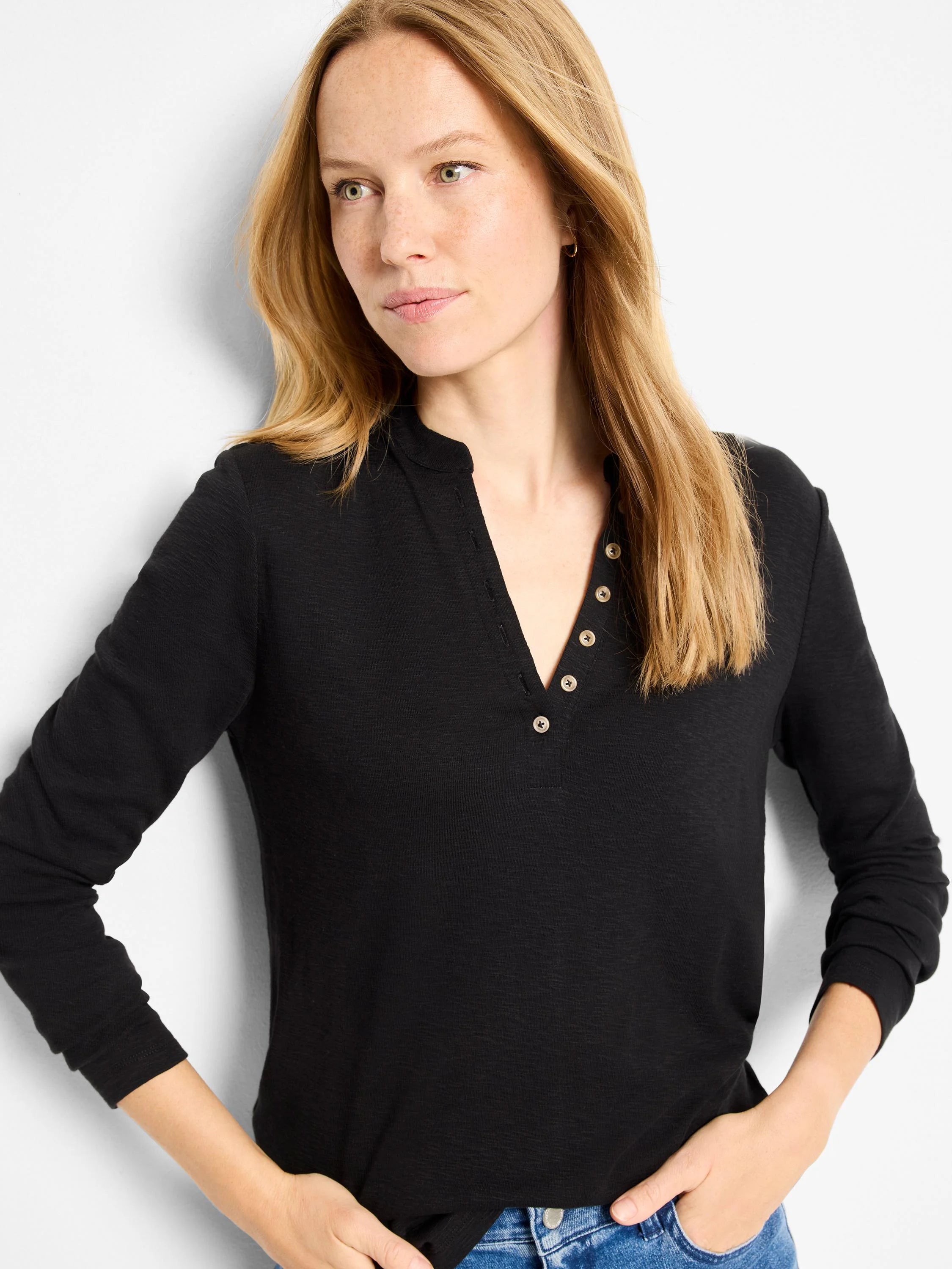 Black long-sleeve henley shirt with  gold buttons and a subtle textured fabric.