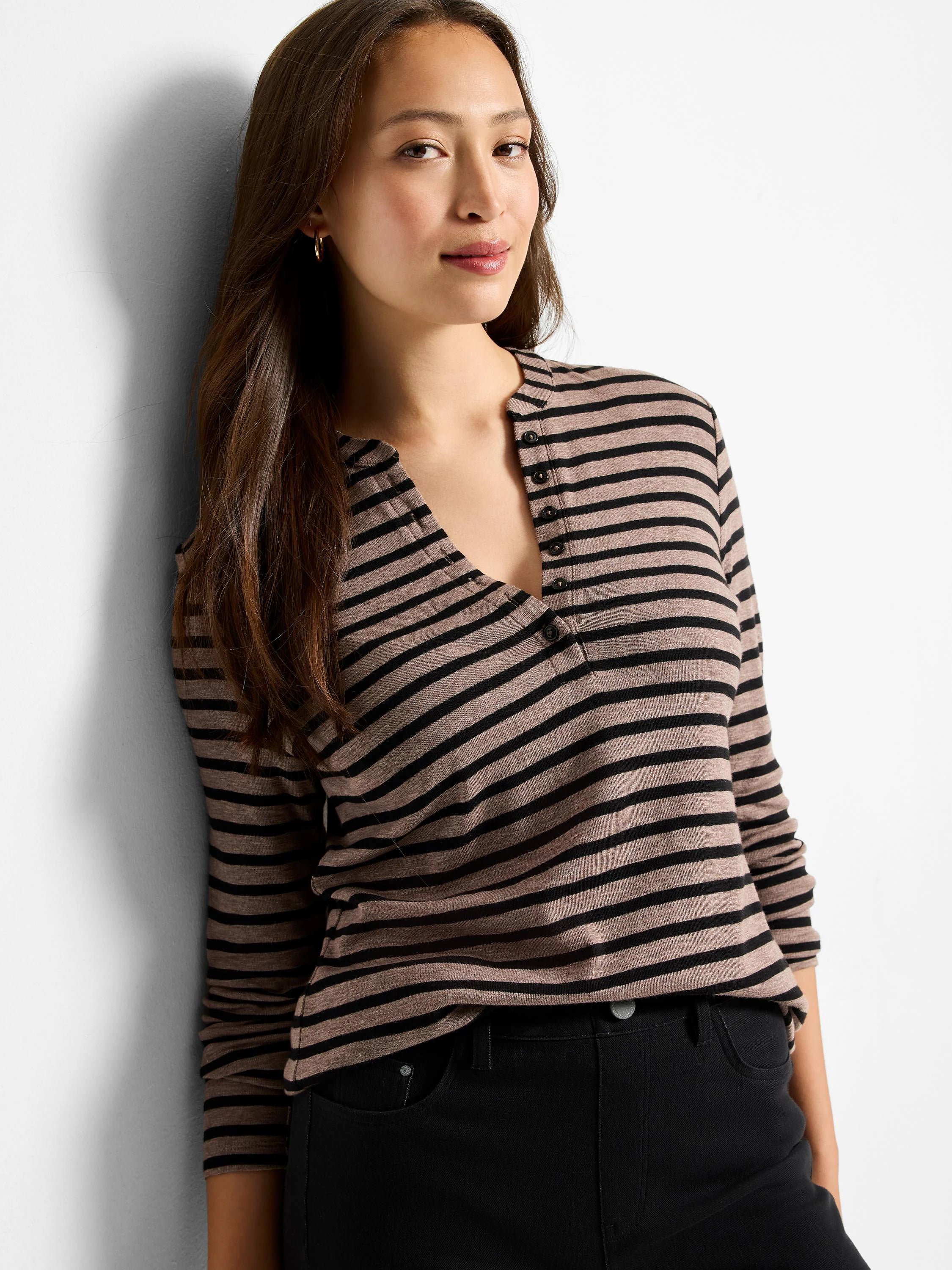 Long-sleeve henley shirt with taupe and black horizontal stripes,  V-neck, and placket with buttons.