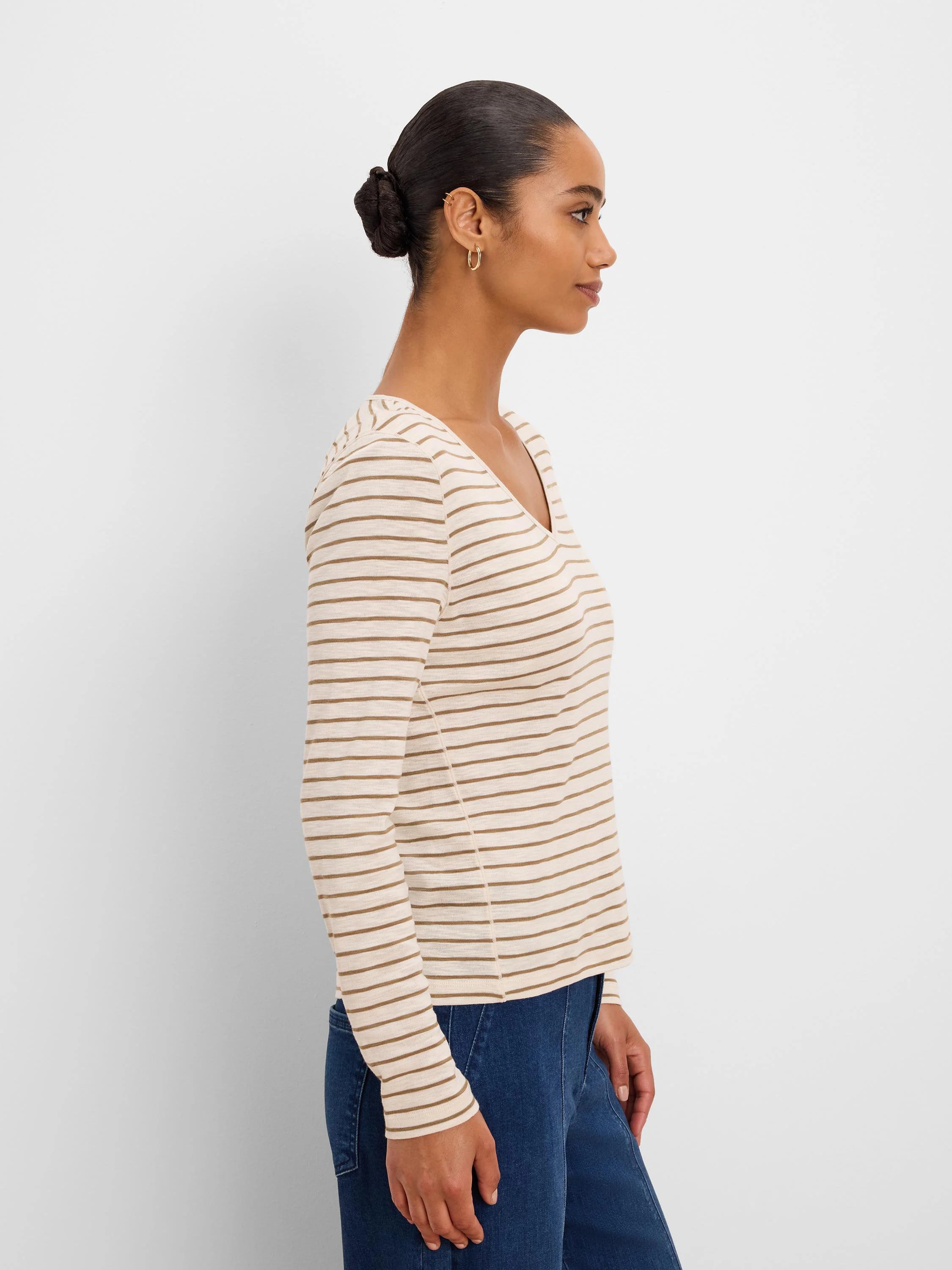 Cream long sleeve tee with thin tan horizontal stripes and a V-neck.