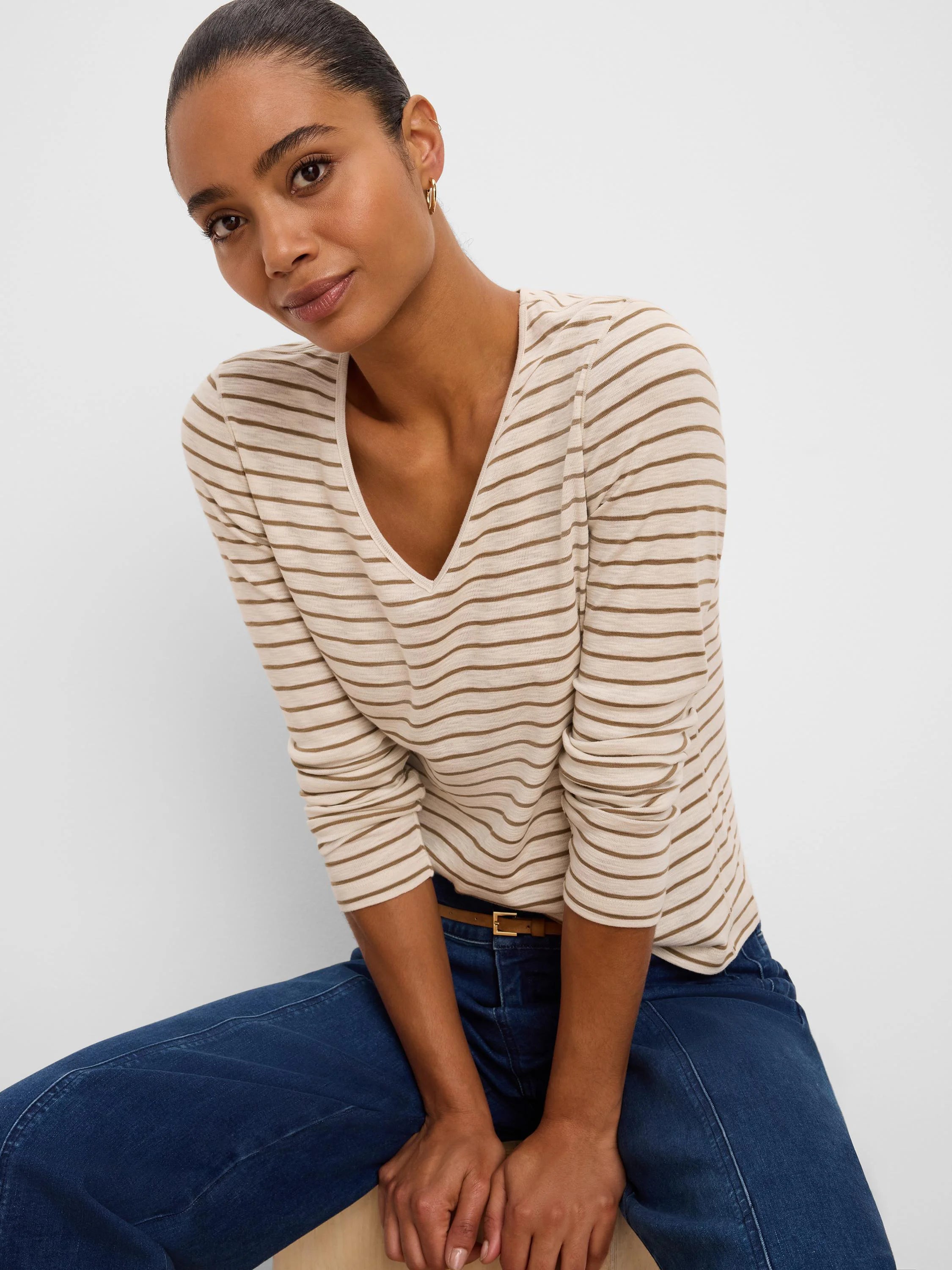 Cream v-neck long sleeve tee with narrow horizontal brown stripes.