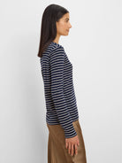 Navy blue long sleeve tee with thin horizontal white stripes.