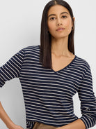 Navy blue and white horizontally striped long sleeve tee with a V-neck.