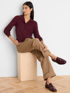Burgundy long-sleeve tee with a snap-button polo collar and gathered puff sleeves.