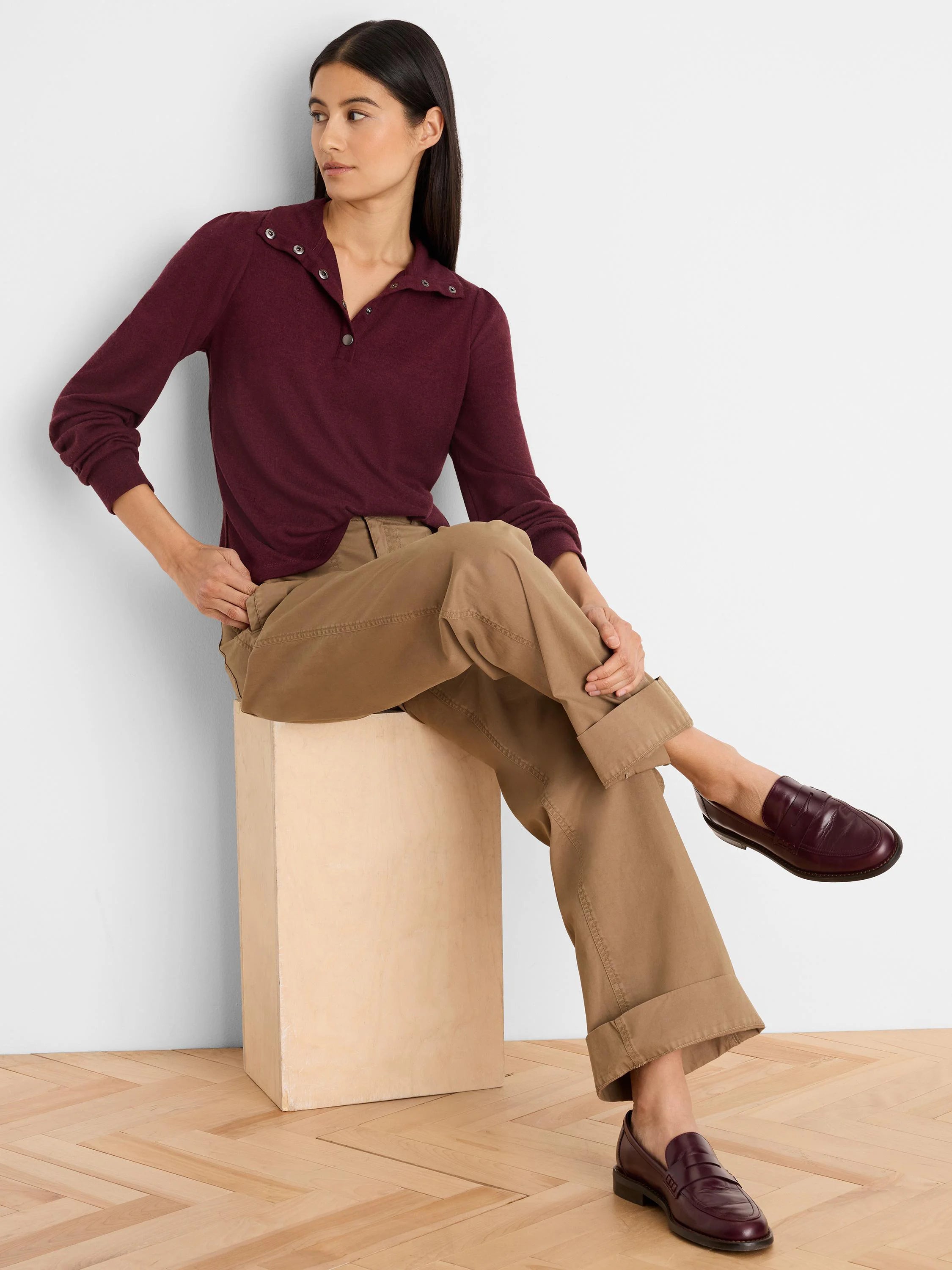 Burgundy long-sleeve tee with a snap-button polo collar and gathered puff sleeves.