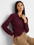 Maroon knit tee with subtle puff long sleeves, collared snap placket, and silver-toned snaps.