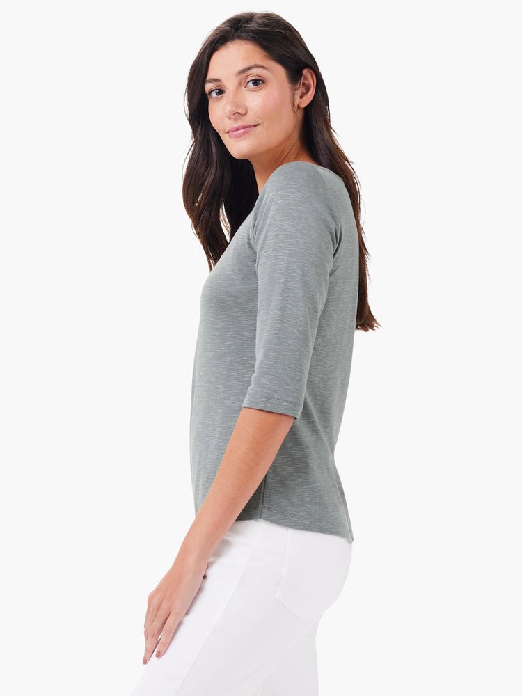 Heathered light green 3/4 sleeve boat neck tee on a woman.