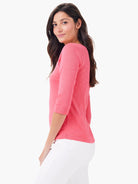 Coral pink 3/4 sleeve boat neck tee with a heathered fabric texture.