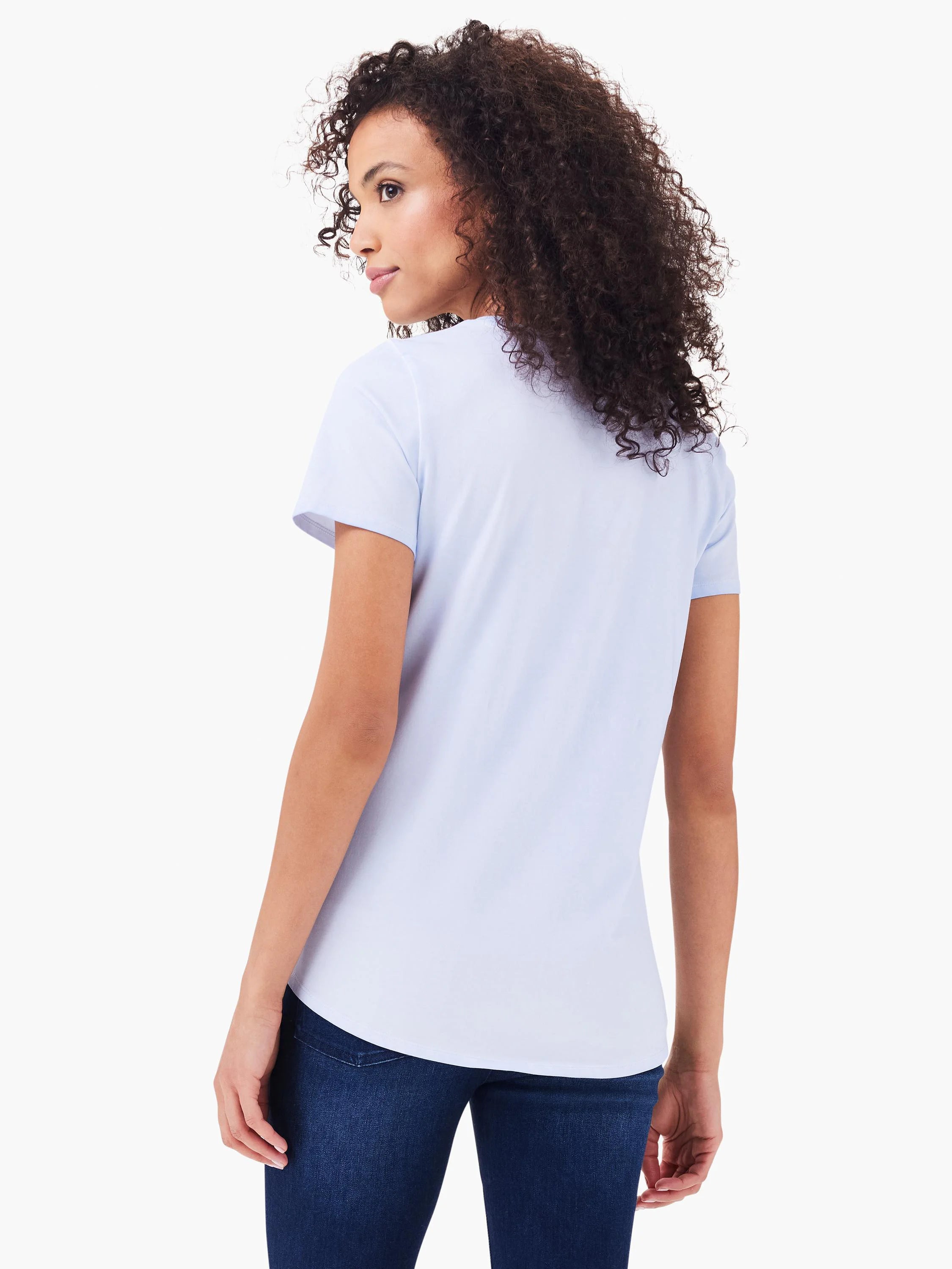 Light blue short sleeve crew neck tee with a curved shirttail hem, shown from the back on a model.