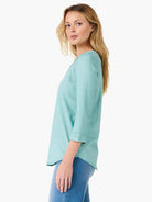 A relaxed mint green v-neck top featuring three-quarter length sleeves and a flattering curved hem.