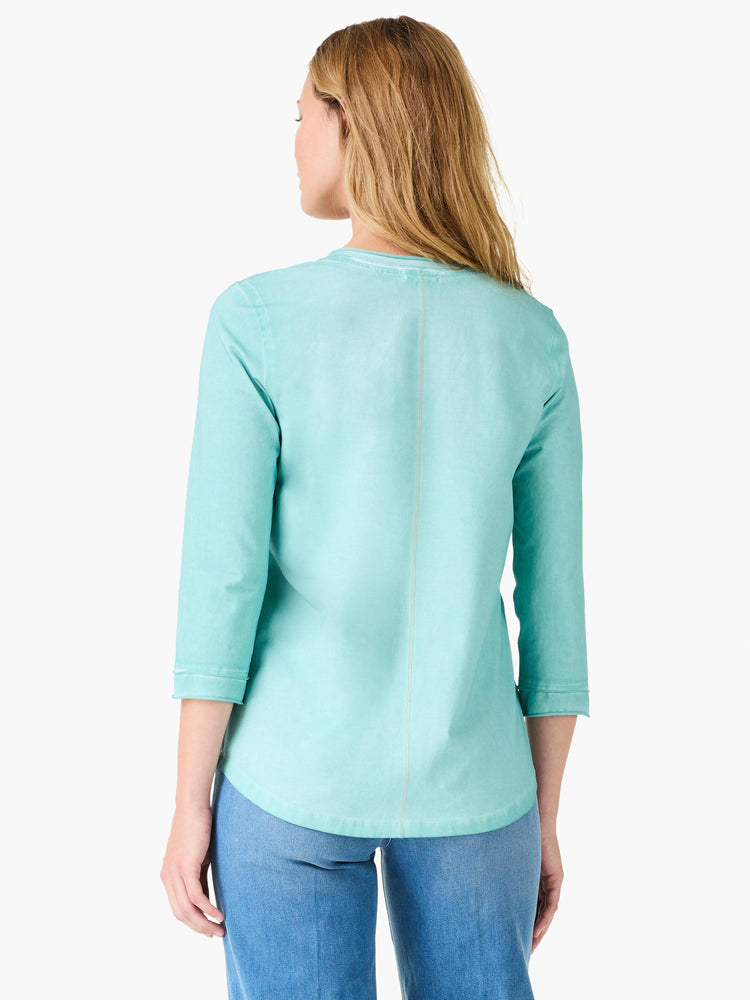 This relaxed aqua top features three-quarter sleeves, a vertical back seam, and a curved hemline.