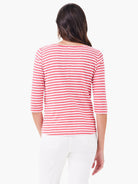 Red and white horizontal striped 3/4 sleeve boatneck shirt; viewed from the back.