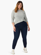 Model wears an off-white and muted green striped 3/4 sleeve boat neck tee.