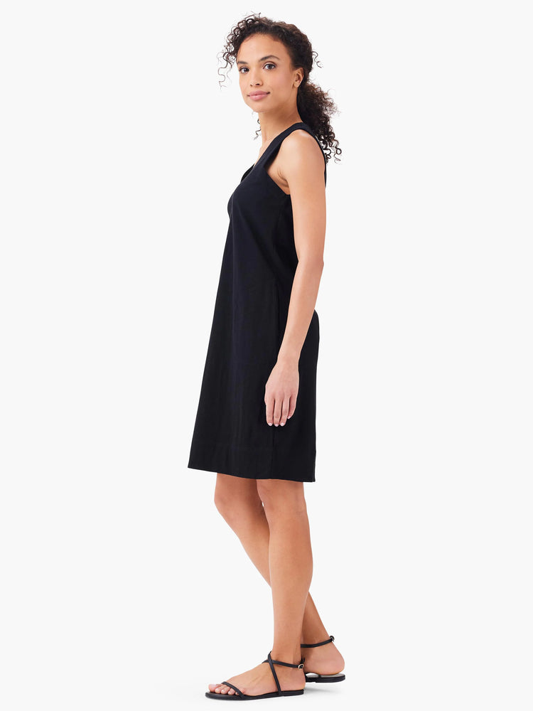 Black sleeveless V-neck mini dress; straight silhouette.