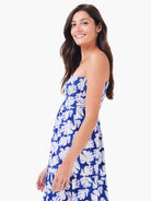 One-shoulder smocked dress, blue and white leaf print, tiered skirt.